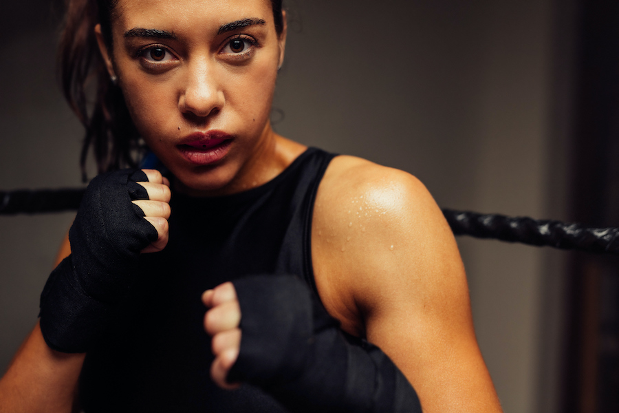 Closeup of a female boxer wearing a mouthguard to protect her teeth