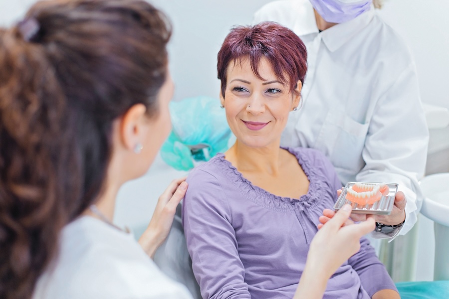 dental implants, dentures, dental implants vs dentures, implant-supported dentures, bone loss, tooth replacement, Alma Dental Care, Petaluma