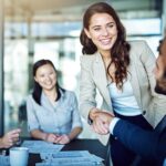 women with straight teeth in business meeting