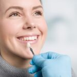woman trying to get natural looking veneers instead of veneers that look fake or unnatural
