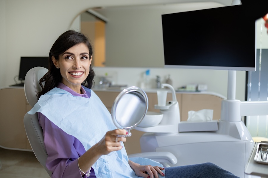 woman in dental chair for cosmetic dental bonding