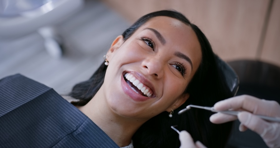 woman in dental chair for a cleaning with the dental hygienist