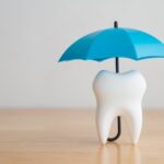 image of umbrella over a tooth for a dental membership plan