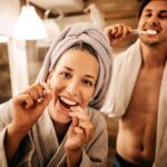 couple brushing their teeth two prevent gum disease or periodontal disease