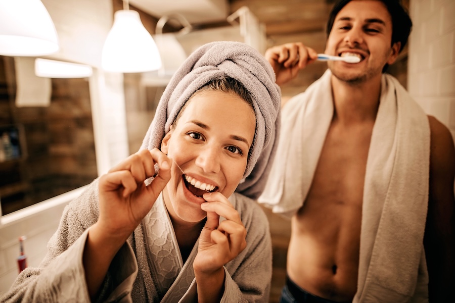 couple brushing their teeth two prevent gum disease or periodontal disease