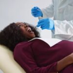 pregnant woman at dental office for dental cleaning or dental treatment to maintain gum health during pregnancy