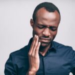 man with tooth sensitivity tooth pain