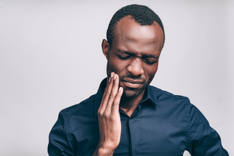 man with tooth sensitivity tooth pain