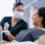 woman explaining treatment plan and dental insurance coverage to patient at dentist
